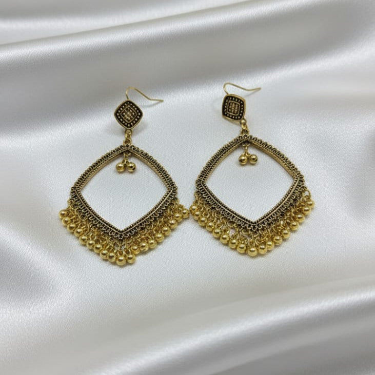 The earrings feature a delicate pattern on the frame and are accented with a fringe of small gold-tone bead charms dangling from the bottom.