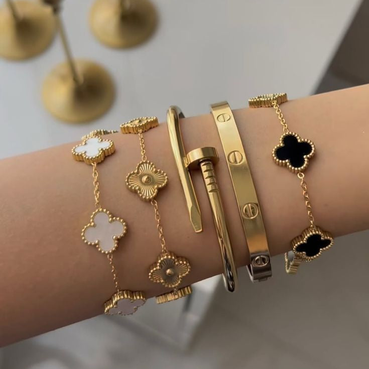 “Luxury gold bracelet set with black and white clover charms – modern jewelry for women”