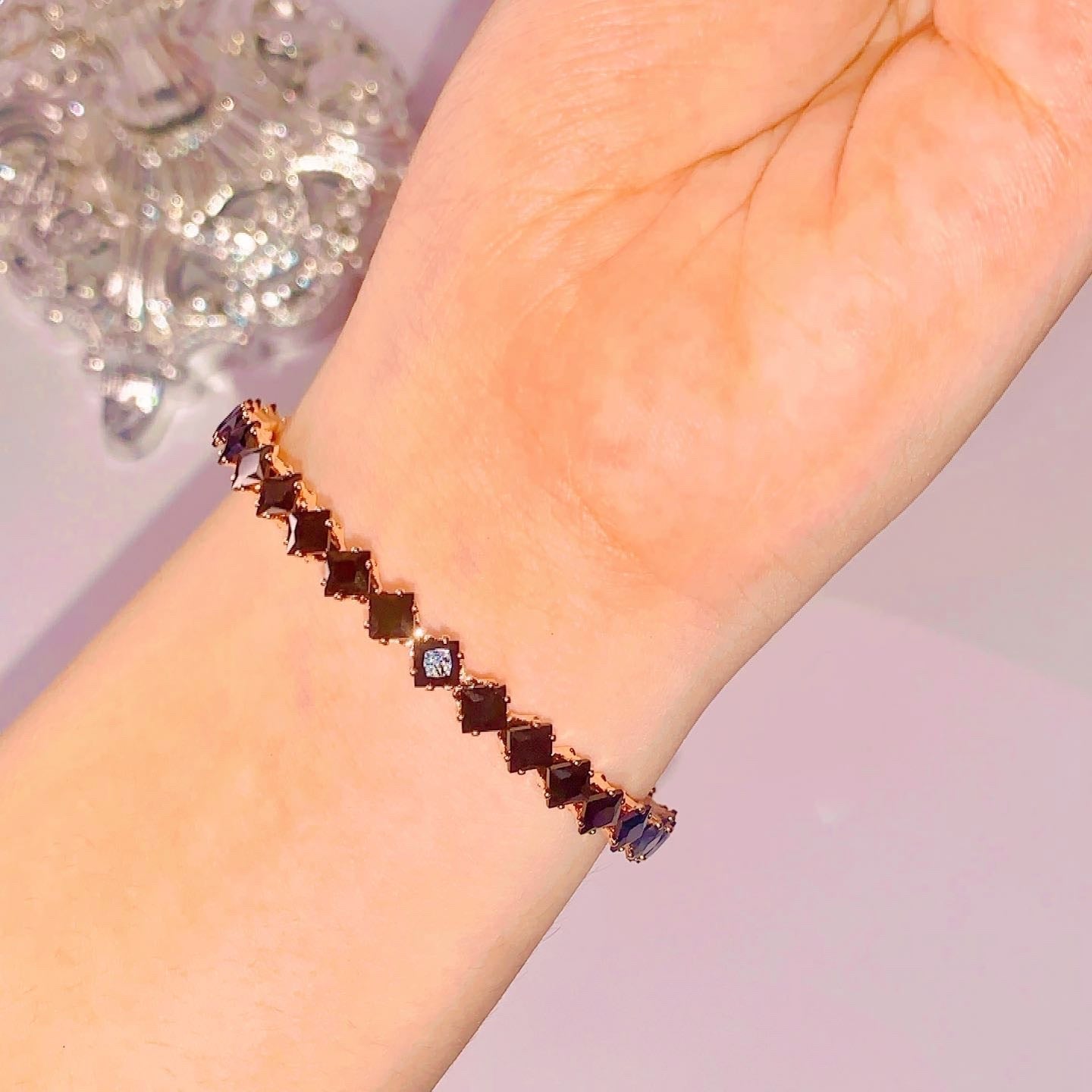โElegant adjustable bangle with sleek non-tarnish finish, fits all wrist sizes.