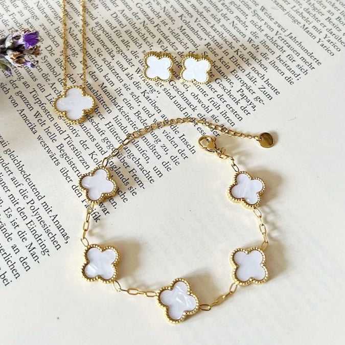 Elegant white enamel clover bracelet, pendant, and stud earrings