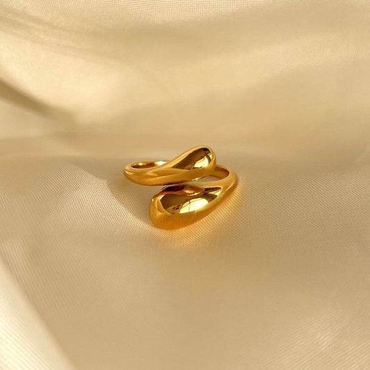 Elegant tear drop ring with adjustable fit, non-tarnish finish.