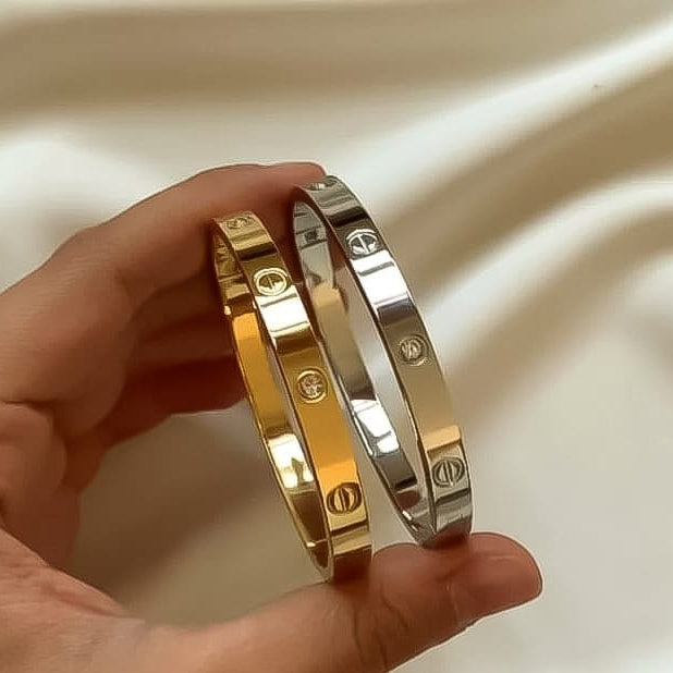 Luxury jewelry Cartier handcuff deal of two, silver and gold openable bracelets.