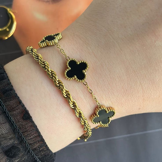 Elegant layered black clover and rope gold bracelets