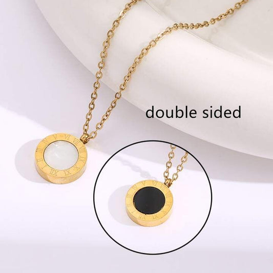 Luxury gold necklace featuring black and white stone pendant design