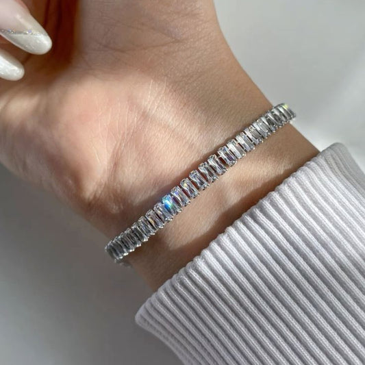 Elegant silver baguette tennis bracelet with cubic zirconia stones on wrist – luxury women’s jewelry