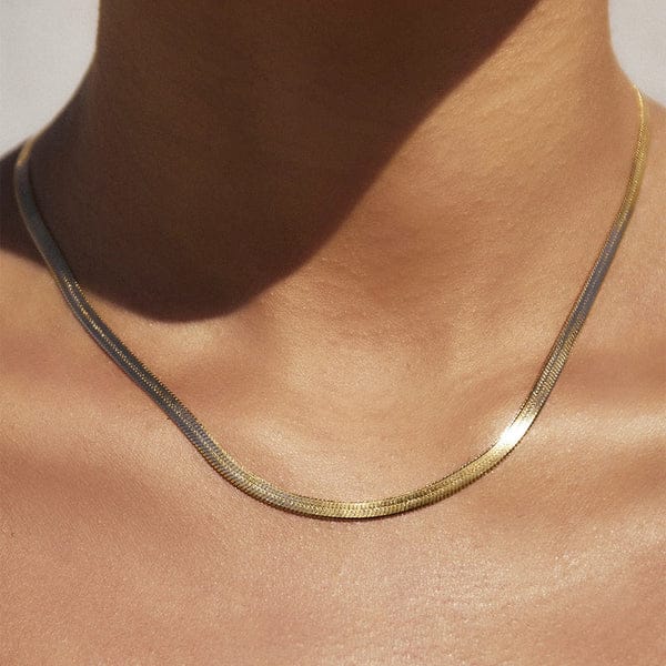 Elegant gold herringbone chain necklace on neck