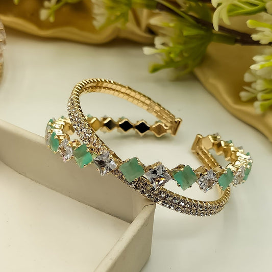 “Gold bracelet pair with sparkling crystals and emerald gems – fashion jewelry for women”