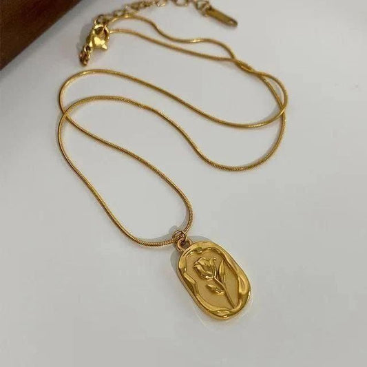 gold-plated pendant necklace with a sculpted rose design