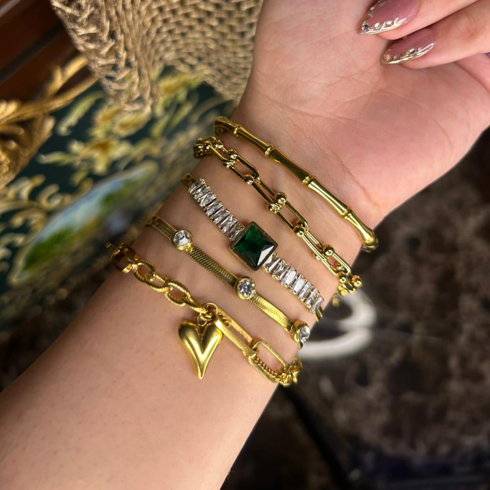 Elegant gold chain bracelet set with green gemstone
