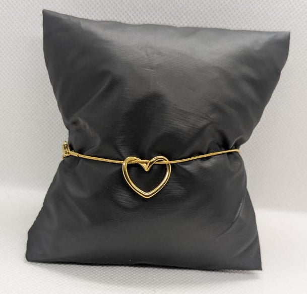 “Elegant golden heart bracelet on black cushion – waterproof and anti-tarnish design”