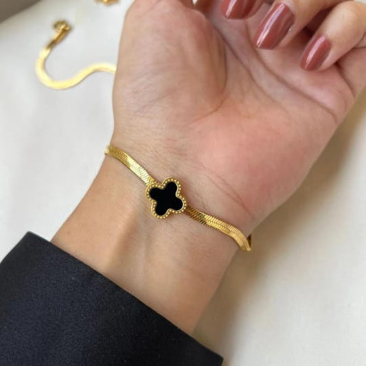 Minimalist black clover gold bracelet on wrist – waterproof hypoallergenic women’s accessory