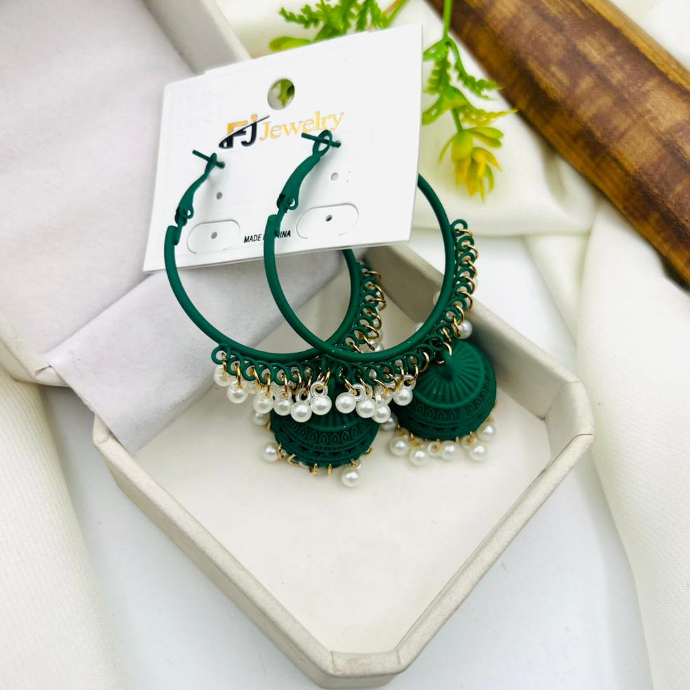 A pair of green hoop earrings with intricate jhumka-style pendants and white pearl detailing