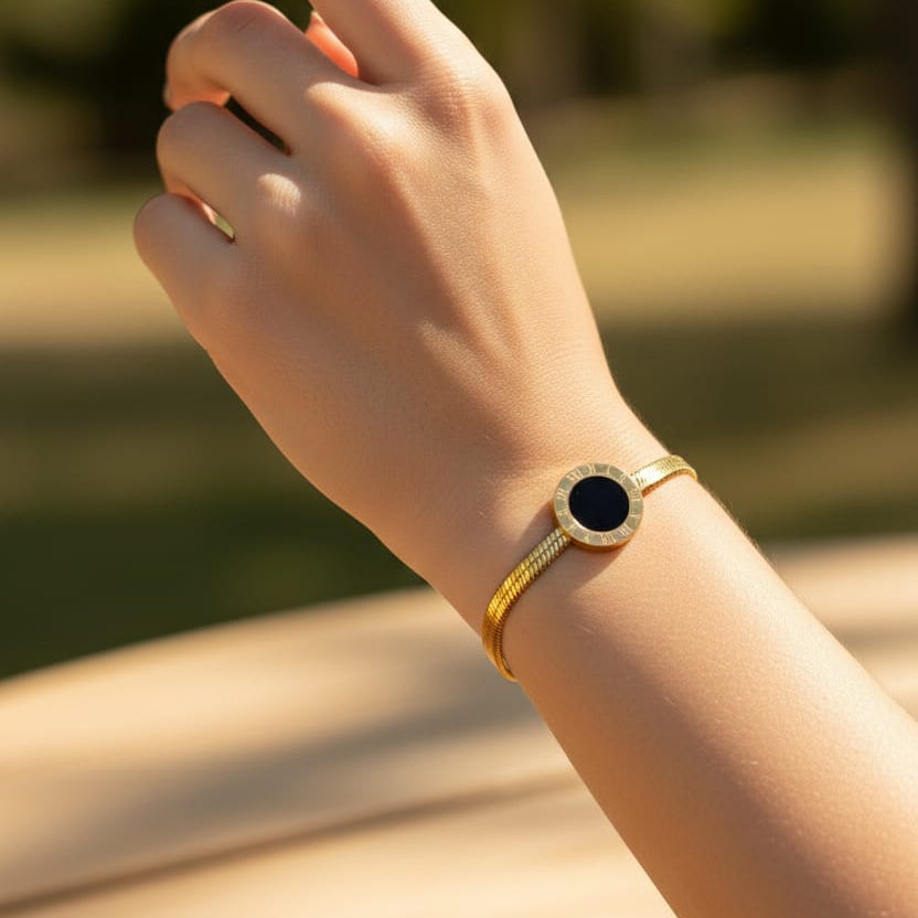 gold-plated Noir bracelet with a black center stone