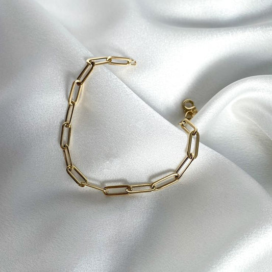Elegant gold paperclip chain bracelet on satin fabric – minimalist stainless steel jewelry