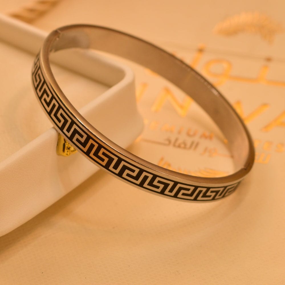 Stainless steel bangle featuring a Greek key design