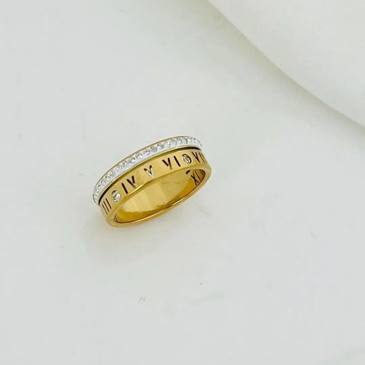 Gold-plated ring with Roman numeral engravings and sparkling stones