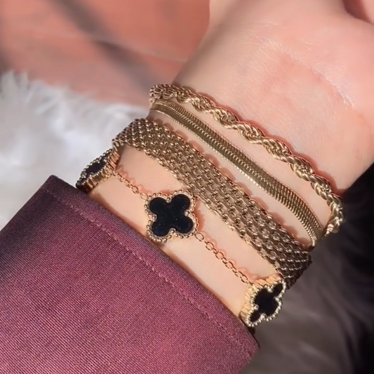 Trendy layered gold bracelets for women – clover charm stack