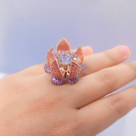 Bold floral lotus design ring with gemstone centerpiece and sparkling petals.