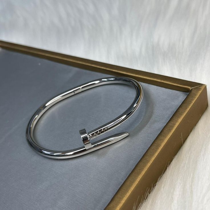 “Modern silver nail bracelet – designer-inspired luxury accessory”