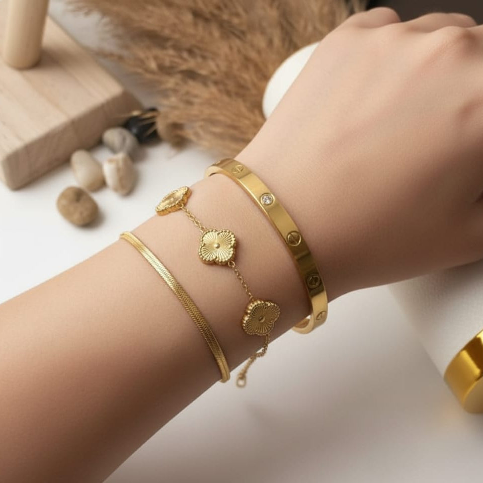 chain bracelet with three clover charms, and a smooth herringbone snake chain bracelet